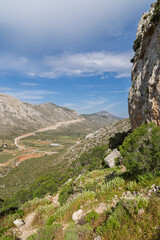 Fototapeta premium Beautiful view of the rocky, lush and mountainous Vathy valley on Kalymnos island in Greece on a sunny day in spring.