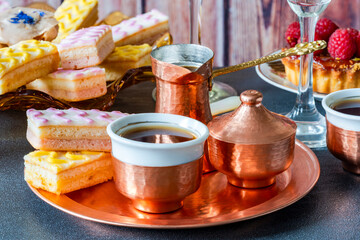 Coffee and selection of gourmet cakes set up on a table