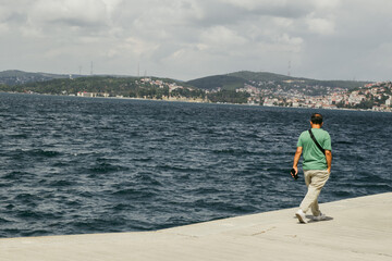 Man walking along the bosphorus strait in Istanbul, Turkey