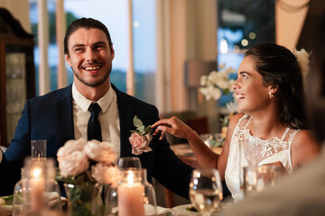 Bride and groom laughing together at elegant wedding reception dinner