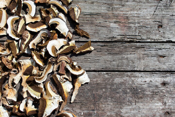 Dried white mushrooms on a wooden table. Copy space.