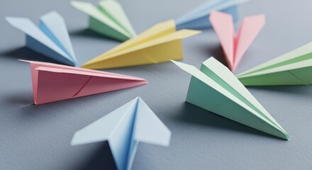 Pastel Paper Airplanes Arranged on a Textured Gray Surface