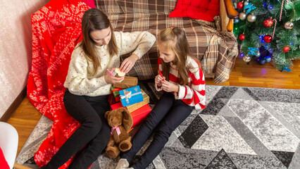 happy family mother and child pack Christmas gifts
