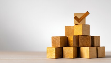 Wooden blocks stacked in a pyramid shape with a check mark