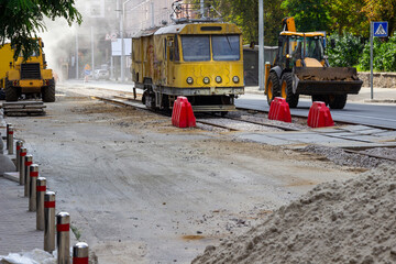 Repair construction equipment. Repair of the road surface on tram tracks