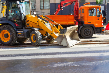 Repair construction equipment. Repair of the road surface on tram tracks