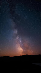 Mobile Wallpaper 4K - Night sky view with the Milky Way galaxy, stars, and a dark mountain silhouette.