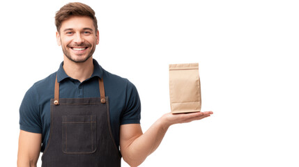 Smiling man in an apron holding a brown paper bag on a white background.