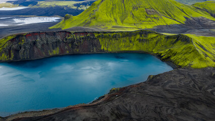 Aerial View of Volcanic Crater Lake with Moss Covered Slopes in Iceland