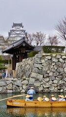 Himeji castle view from garden grounds with lake in the foreground
