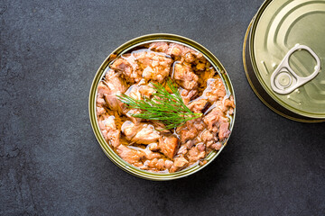Canned tuna in brine isolated on black background	