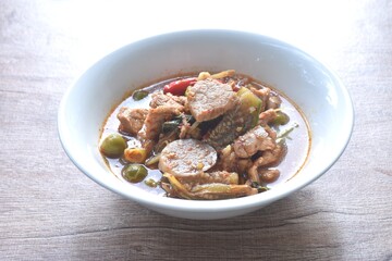 spicy boiled pork with mixed vegetable in jungle curry soup Thai food in bowl