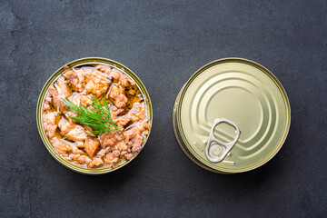 Canned tuna in brine isolated on black  background