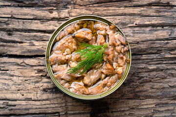 Canned tuna in brine isolated on wooden background	