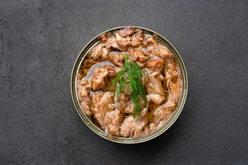 Canned tuna in brine isolated on black  background