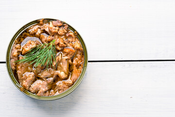 Canned tuna in brine isolated on white wooden background