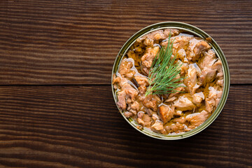 Canned tuna in brine isolated on white wooden background	
