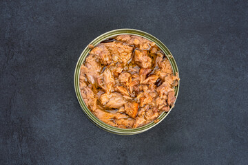 Canned tuna in brine isolated on black  background