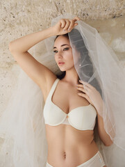 Girl model in lingerie posing in a photo studio, beautiful lingerie and loft atmosphere.