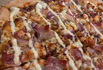 Fusion pizza with onions and bacon, barbecue pizza with cheese sauce