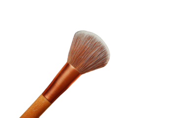 Close-up of a makeup brush, light tan handle, copper-toned ferrule, fluffy blush tip