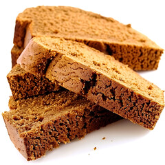 Slices of moist gingerbread loaf stacked on a white background