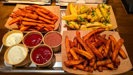 Sweet potato fries and classic french fries with dipping sauces
