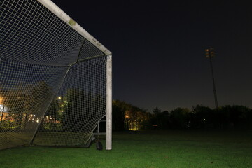 Fototapeta premium Empty football goal at night. Green field and grass. Viksjö, Järfälla, Stockholm, Sweden.