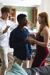 Fototapeta premium Teen friends celebrating at home, enjoying drinks and lively conversation together