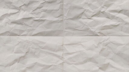 Obraz premium Crumpled and folded beige paper surface with wrinkled texture. Pattern of folded old beige paper. Blank beige paper folded in four fraction background. Ideal for backgrounds and space for text.