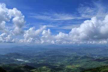 Vast green mountains under blue sky with white clouds