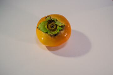 Ripe persimmon fruit isolated on white background, top view