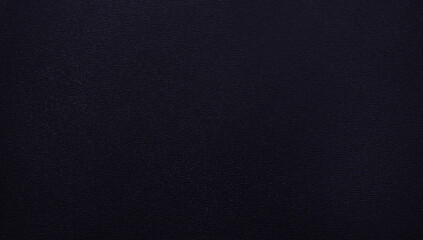 Monochrome neutral backdrop. Close up of dark midnight denim blue textured leather surface with subtle grain pattern, matte finish and realistic detail, for backgrounds, stylish design project. 