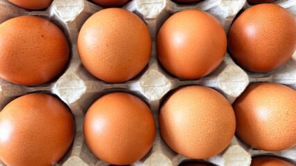 Eggs in paper tray, top view. Fresh farm eggs in eco packaging, organic food, healthy eating concept