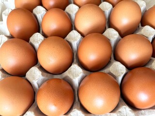 Eggs in paper tray, top view. Fresh farm eggs in eco packaging, organic food, healthy eating concept