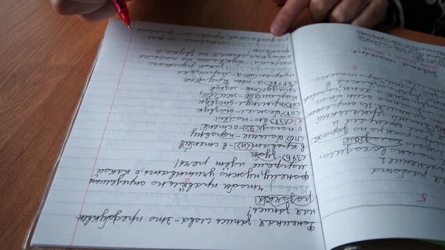 The teacher checks the students' notebooks