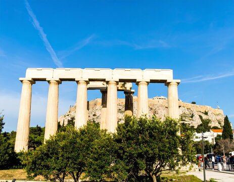 Ancient columns against a clear blue sky - Powered by Adobe