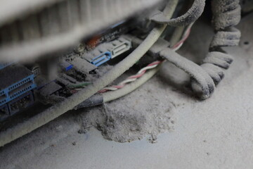 A detailed shot of a grimy metal computer fan resting on a clean white tabletop, reminiscent of automotive tire components like alloy wheels, rims, and hubcaps