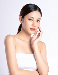Graceful Beauty: A young woman exhibits an elegant, natural beauty. Her smooth skin glows under the soft studio light, reflecting a sense of serene confidence and pure, unspoiled allure.