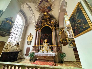 Naklejka premium The altar of St. Peter's Church surrounded by masterpieces of world icon painting. gilded bas-reliefs of saints and an unsurpassed ceiling painting that glorifies the one God.