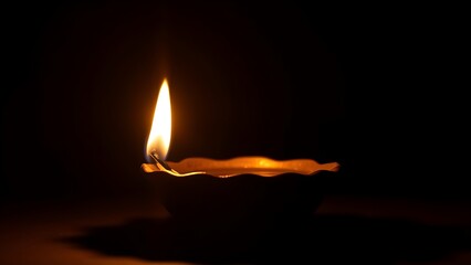 A golden oil lamp glows warmly against a dark backdrop, its flickering flame creating a cozy atmosphere.