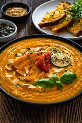 Pumpkin cream soup on wooden table	