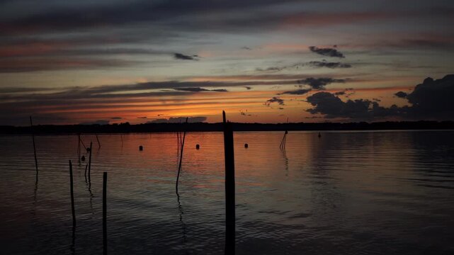 Peaceful sunset over Schwielowsee in Caputh Brandenburg, filmed from the Caputher Gem&uuml;nde observation platform during twilight.