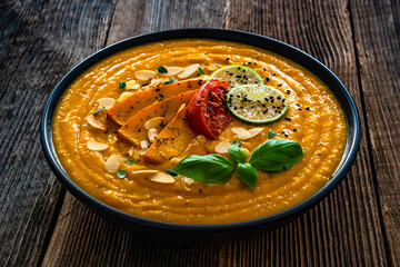 Pumpkin cream soup on wooden table	