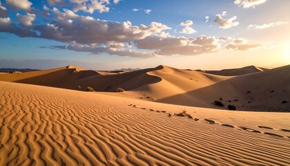 A breathtaking desert landscape unfolds, featuring vast sand dunes under a partly cloudy sky at golden hour, with footprints