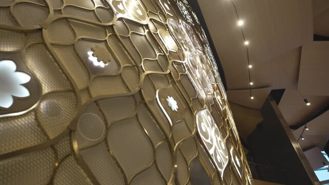 Golden partition decorated with ornaments glimmers softly. Delicate curves express heritage creativity and sophisticated aesthetics
