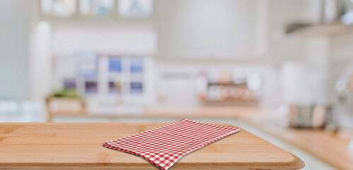 Empty wooden countertop with checkered napkin in modern kitchen