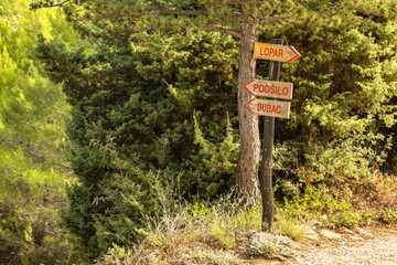 Wooden signs on the trail directing tourists to sandy beaches, Podsilo, Sahara, Dubac, on the island of Rab