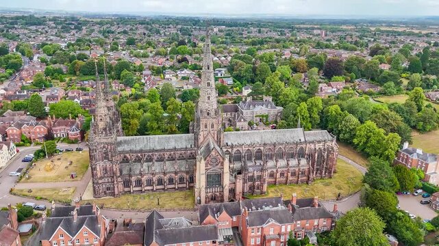 A rising aerial view of the cathedral in the town of Lichfield, UK in summertime