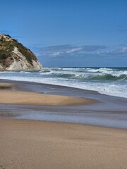 a beautiful shot of the beach with a blue sky